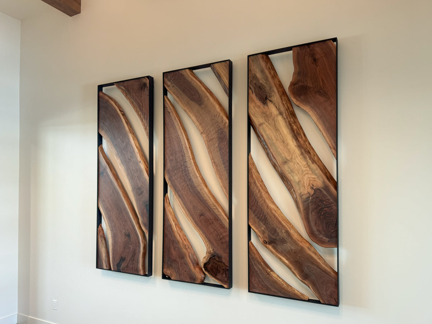 Side view of an 84-inch live-edge walnut triptych wall sculpture