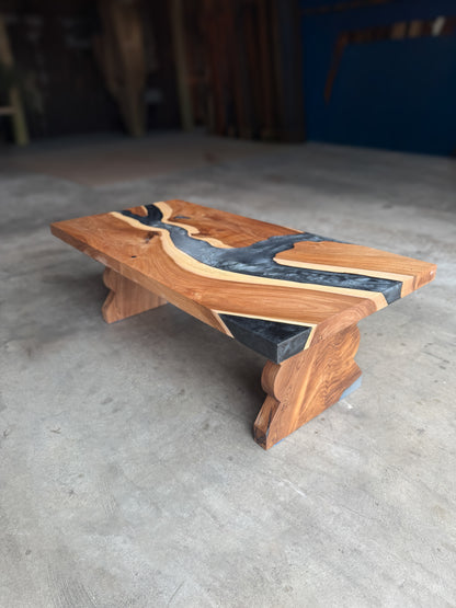 American elm coffee table with charcoal-grey epoxy river and custom-shaped solid elm legs
