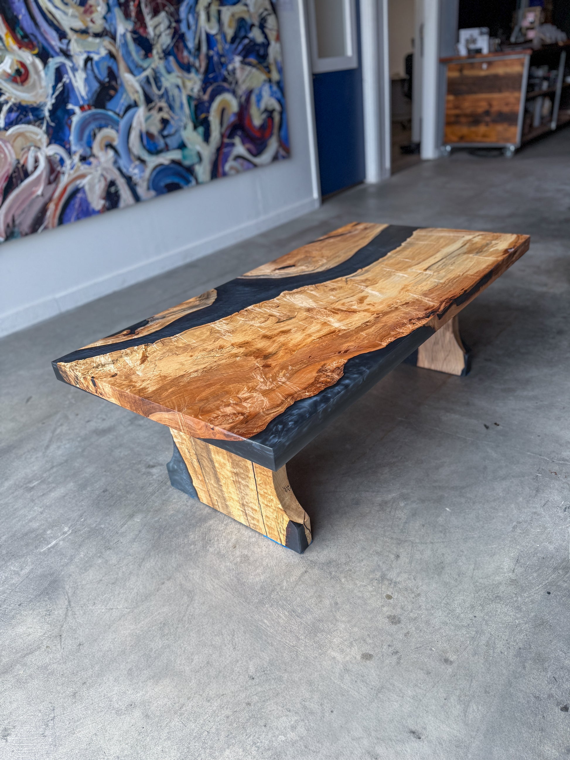 Spalted maple coffee table with caviar-black epoxy river and matching spalted maple pedestal legs