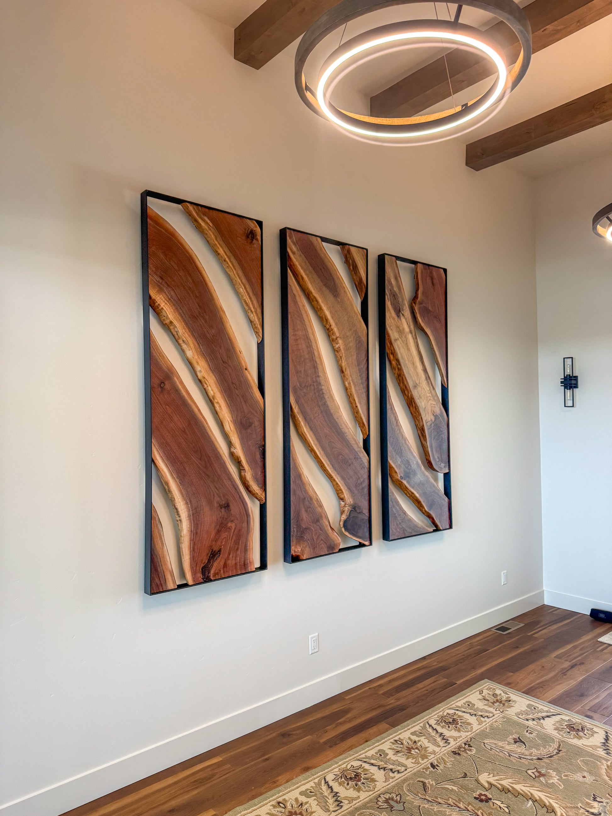 Side view of black walnut wall sculpture with open space behind the live-edge slabs