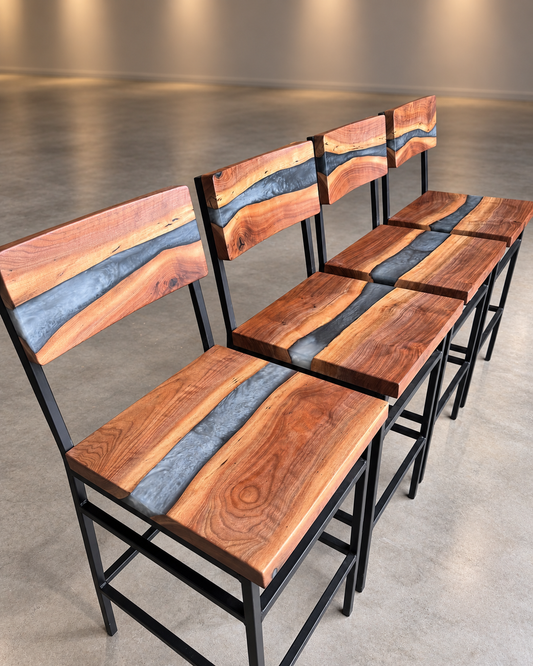 Custom black walnut and grey resin bar stools displayed in a clean, neutral showroom.