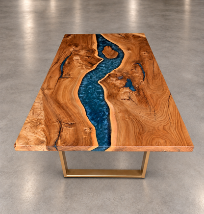Custom American elm dining table with a dark blue resin river and gold metal base, centered on a clean neutral floor.