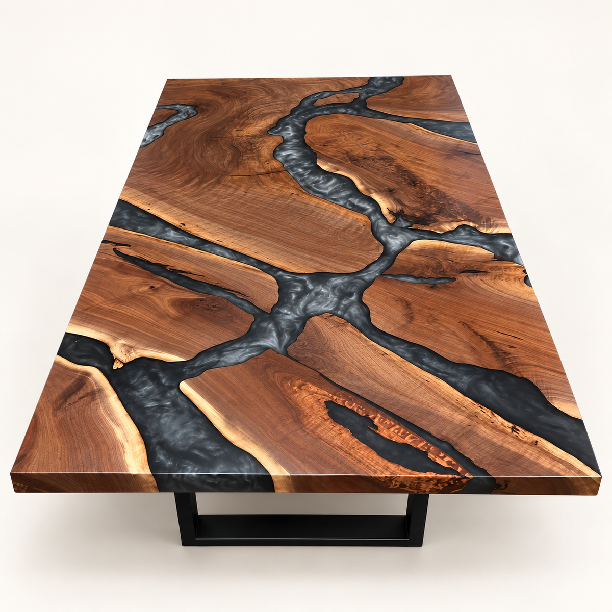 Black walnut coffee table with branching multi-grey epoxy river and black metal base on a warm-white background.