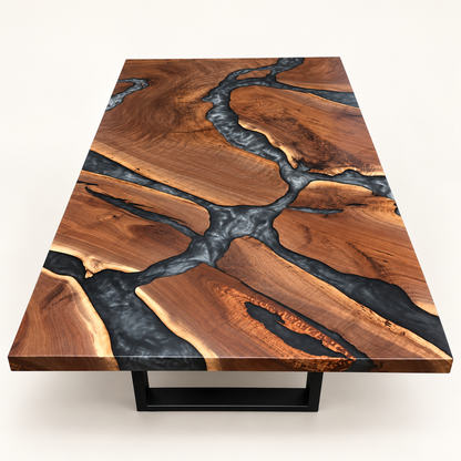 Black walnut coffee table with branching multi-grey epoxy river and black metal base on a warm-white background.